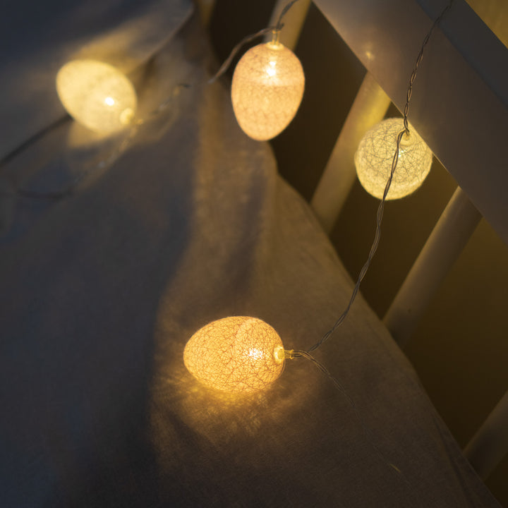 10 LED Cotton Egg Lights illuminating a bed