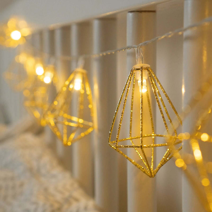 Detailed view of golden diamond-shaped lights on the string