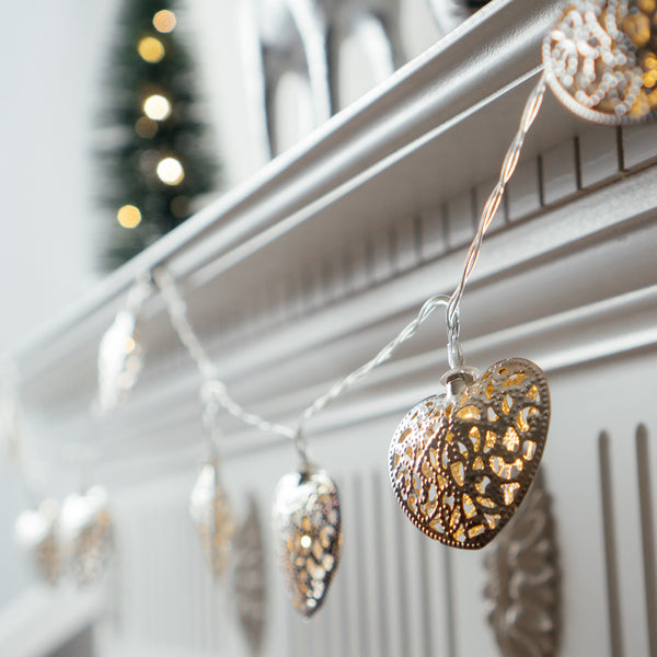 String of 10 LED Silver Filigree Heart Fairy Lights on a mantle