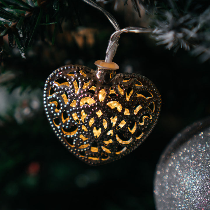 Silver Filigree Heart Fairy Light hanging as a Christmas tree ornament