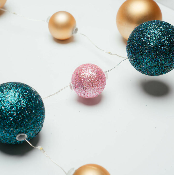 15 LED Bauble Fairy String Light spread out on a white surface