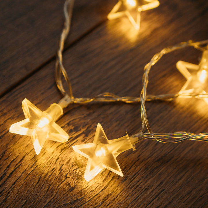 LED star lights displayed on a wooden table