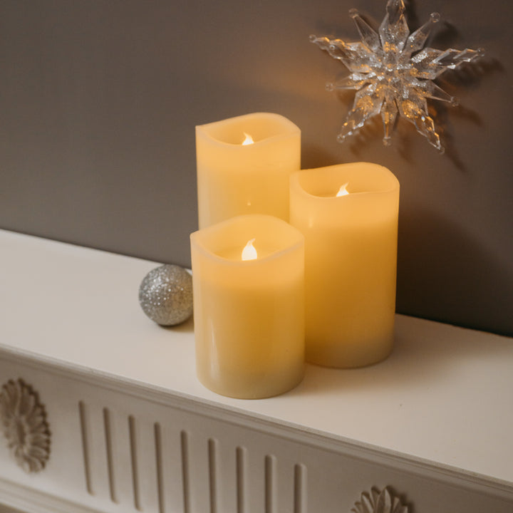 Trio of LED candles from the 3pc set displayed on a mantelpiece